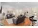 Spacious living room with hardwood floors, recessed lighting, and comfortable seating, perfect for relaxation and entertaining at 4457 Equity Ct, Ellenwood, GA 30294