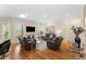 Spacious living room with a cozy fireplace, hardwood floors, and plenty of seating at 4457 Equity Ct, Ellenwood, GA 30294
