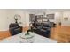 Inviting living room featuring hardwood floors, comfortable seating, and an open layout leading to the kitchen area at 4457 Equity Ct, Ellenwood, GA 30294