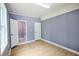 Bedroom with neutral walls and wood floors, showing access to the ensuite bathroom at 5251 Joan Of Arc Pl, Atlanta, GA 30349