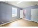 Bedroom with neutral walls and light wood floors, showcasing an ensuite bathroom at 5251 Joan Of Arc Pl, Atlanta, GA 30349