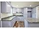 Modern kitchen featuring granite countertops, white backsplash, and stainless steel appliances at 5251 Joan Of Arc Pl, Atlanta, GA 30349