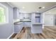 Charming kitchen with granite countertops, an island, light purple cabinets, and wood floors at 5251 Joan Of Arc Pl, Atlanta, GA 30349