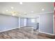 Spacious living room with hardwood floors, recessed lighting, and a glimpse of the kitchen at 5251 Joan Of Arc Pl, Atlanta, GA 30349
