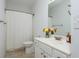 Bright bathroom featuring white cabinets, granite countertops, and a shower with a white curtain at 133 Newcastle Walk, Woodstock, GA 30188