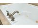 A close-up shows the brushed-nickel faucet and jets of a built-in white bathtub at 133 Newcastle Walk, Woodstock, GA 30188