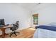 Cozy bedroom featuring a work area, window, and neutral walls at 133 Newcastle Walk, Woodstock, GA 30188