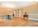 Open-concept dining room with hardwood floors, chandelier, stairs, and an arched entryway at 133 Newcastle Walk, Woodstock, GA 30188