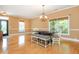 Inviting dining room featuring hardwood floors, a decorative door, and large windows at 133 Newcastle Walk, Woodstock, GA 30188