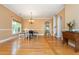 Bright dining room featuring hardwood floors, a chandelier, an arched entryway, and large windows at 133 Newcastle Walk, Woodstock, GA 30188