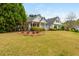 Inviting home exterior surrounded by lush greenery and a neatly maintained lawn at 133 Newcastle Walk, Woodstock, GA 30188