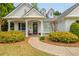 A welcoming front porch with a charming walkway and colorful landscaping at 133 Newcastle Walk, Woodstock, GA 30188