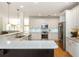 Spacious kitchen featuring white cabinets, granite counters, and stainless steel appliances at 133 Newcastle Walk, Woodstock, GA 30188