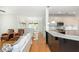 Open concept living and kitchen area with modern cabinetry, hardwood floors and pendant lighting at 133 Newcastle Walk, Woodstock, GA 30188