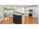 Open concept kitchen with white cabinets, granite counters, stainless appliances, and breakfast bar at 133 Newcastle Walk, Woodstock, GA 30188