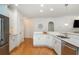 Modern kitchen featuring stainless steel appliances, white cabinets, and wood floors at 133 Newcastle Walk, Woodstock, GA 30188