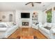 Spacious living room with fireplace, built in shelving, 3 couches, and large windows at 133 Newcastle Walk, Woodstock, GA 30188