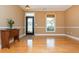Inviting living room with hardwood floors, a decorative door, and neutral walls, creating a welcoming space at 133 Newcastle Walk, Woodstock, GA 30188
