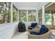 Inviting screened porch with comfortable wicker seating and outdoor grill overlooking the backyard at 133 Newcastle Walk, Woodstock, GA 30188
