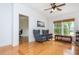 Bright sitting room with wood floors, vaulted ceilings, large windows, and two grey wingback chairs at 133 Newcastle Walk, Woodstock, GA 30188