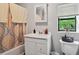 Bathroom boasts natural light from the window, neutral decor, and a tub shower combo at 3750 Mckown Rd, Douglasville, GA 30134