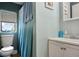 Bathroom featuring a toilet, window, vanity, and a shower with blue shower curtain at 3750 Mckown Rd, Douglasville, GA 30134