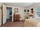 Bright bedroom features a dresser, mirror, natural light from the window, and white neutral decor at 3750 Mckown Rd, Douglasville, GA 30134