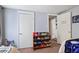 Bright bedroom with a gray wall, white doors, and colorful toy storage at 3750 Mckown Rd, Douglasville, GA 30134