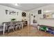 Dining area boasts farmhouse decor, dining table with metal chairs, and view into the living room at 3750 Mckown Rd, Douglasville, GA 30134