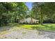 Home surrounded by mature trees, and a gravel drive in a quiet setting at 3750 Mckown Rd, Douglasville, GA 30134