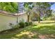 Side view of a home featuring manicured bushes, and mature trees at 3750 Mckown Rd, Douglasville, GA 30134