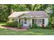 Charming single-story home with a well-maintained lawn and lush landscaping in a peaceful, wooded neighborhood at 3750 Mckown Rd, Douglasville, GA 30134
