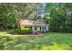 Charming home with lush green lawn, mature trees, and inviting front porch at 3750 Mckown Rd, Douglasville, GA 30134