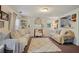 Bright living room with neutral tones, a decorative fireplace, and an open view to the kitchen enhances a cozy atmosphere at 3750 Mckown Rd, Douglasville, GA 30134
