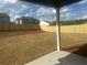 Fenced in back yard of new home in suburban neighborhood with grass at 415 Rodeo Dr, Auburn, GA 30102