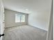 Bright bedroom features large window, soft carpet, and neutral paint at 415 Rodeo Dr, Auburn, GA 30102