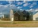 Two-story home showcasing brick and siding, complemented by a well-manicured lawn at 415 Rodeo Dr, Auburn, GA 30102