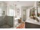 This bathroom features a marble shower, freestanding tub, patterned rug, and modern fixtures at 427 Cherokee Se Ave, Atlanta, GA 30312