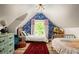 ' bedroom features a blue accent wall, twin beds, and patterned rug at 427 Cherokee Se Ave, Atlanta, GA 30312
