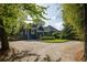 Charming blue home with a large gravel driveway and beautiful mature trees at 427 Cherokee Se Ave, Atlanta, GA 30312