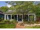 Charming blue two-story home with a covered front porch and blossoming tree in the landscaped front yard at 427 Cherokee Se Ave, Atlanta, GA 30312