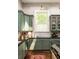 Inviting kitchen featuring sage green cabinets, modern appliances, and sleek countertops at 427 Cherokee Se Ave, Atlanta, GA 30312