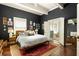 Spacious main bedroom with a dark accent wall, wood floors, and an ensuite bathroom at 427 Cherokee Se Ave, Atlanta, GA 30312