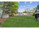 Spacious backyard with a large green lawn and mature trees; perfect for outdoor activities at 422 Laurian Nw Way, Kennesaw, GA 30144