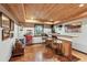 Basement bar area with wood paneling, custom bar, and unique decorative accents at 422 Laurian Nw Way, Kennesaw, GA 30144