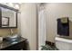 Well-lit bathroom with a stylish vessel sink, dark vanity, and shower with a white curtain at 422 Laurian Nw Way, Kennesaw, GA 30144