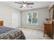 Neutral bedroom with a ceiling fan, closet, and a window provides ample natural light at 422 Laurian Nw Way, Kennesaw, GA 30144