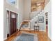 A beautiful foyer with hardwood floors, a staircase, and a dark stained entry door at 422 Laurian Nw Way, Kennesaw, GA 30144