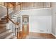 Open foyer featuring hardwood floors, neutral paint, staircase, and an open doorway to a living space at 422 Laurian Nw Way, Kennesaw, GA 30144