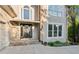 A close up of a home's front door with stone accents, flower pots, and sconces at 422 Laurian Nw Way, Kennesaw, GA 30144